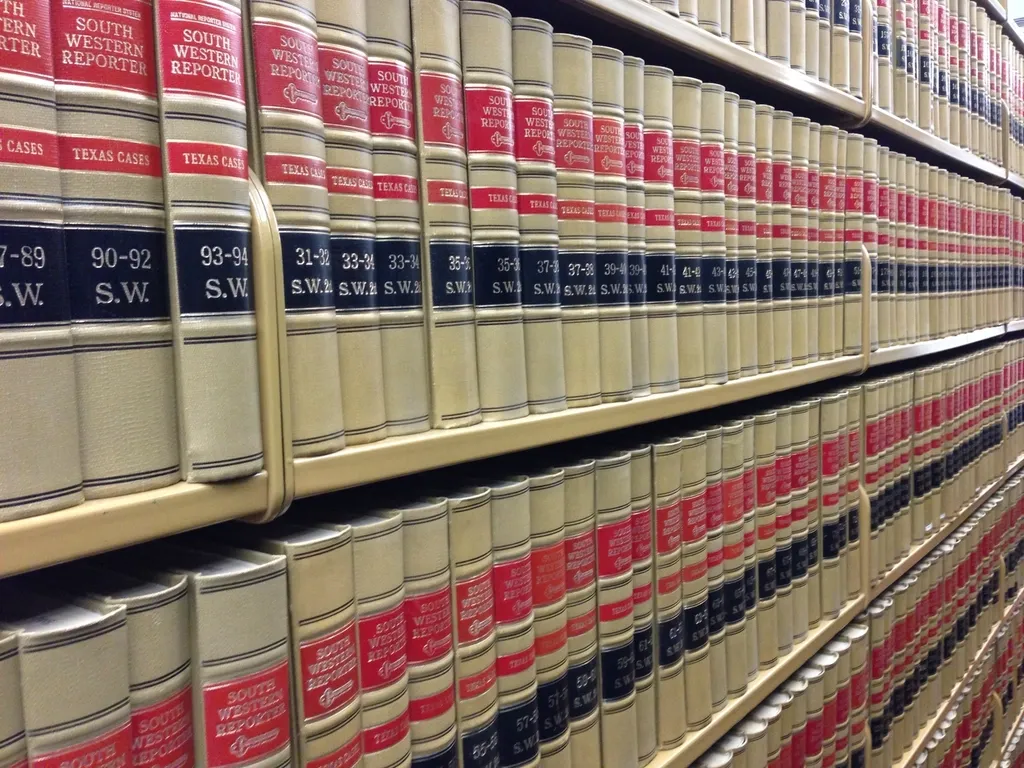 Long rows of bound law reports on library shelves